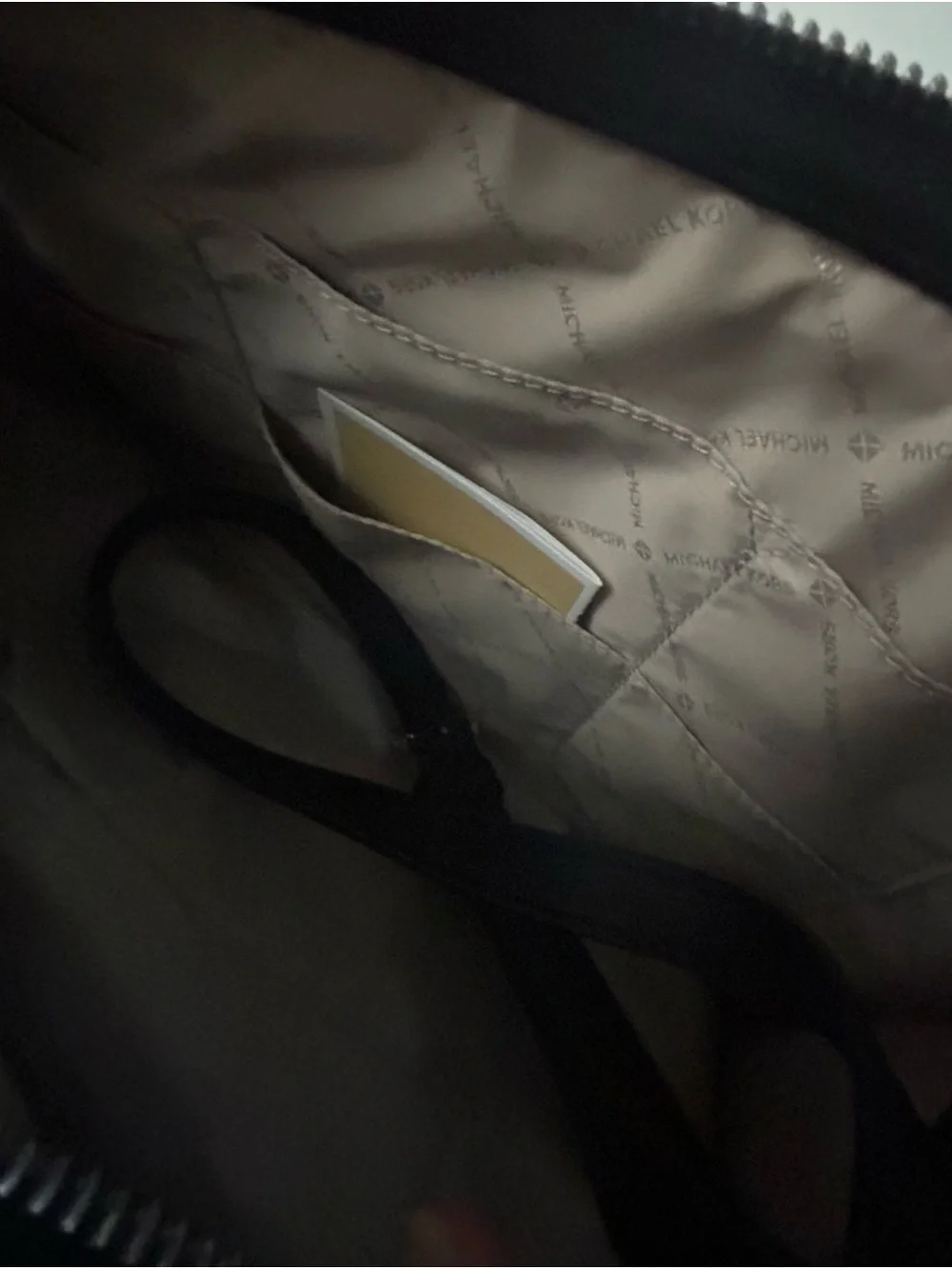 Michael Kors White Perforated Satchel with Black Trim and matching black wallet.